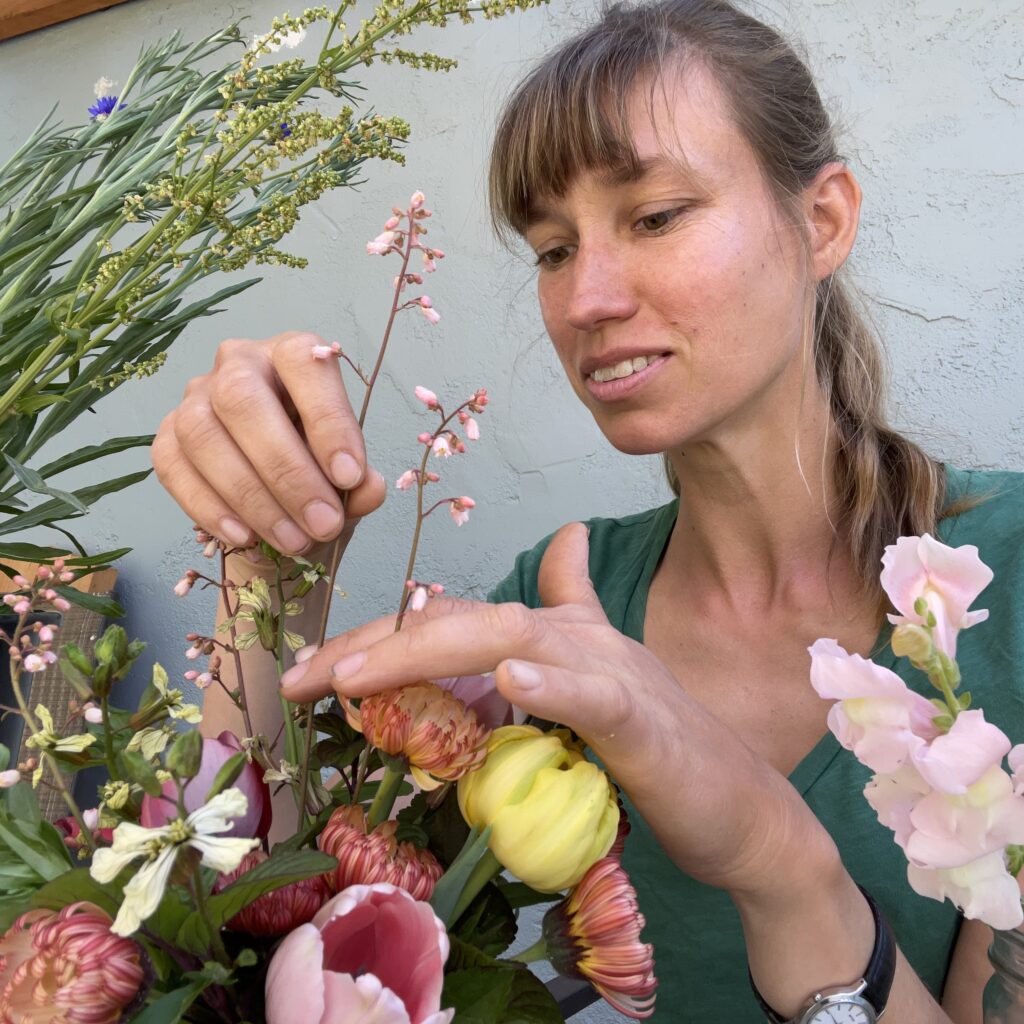 Lisa Molle Troyer arranging locally grown flowers for Thicket in Monterey